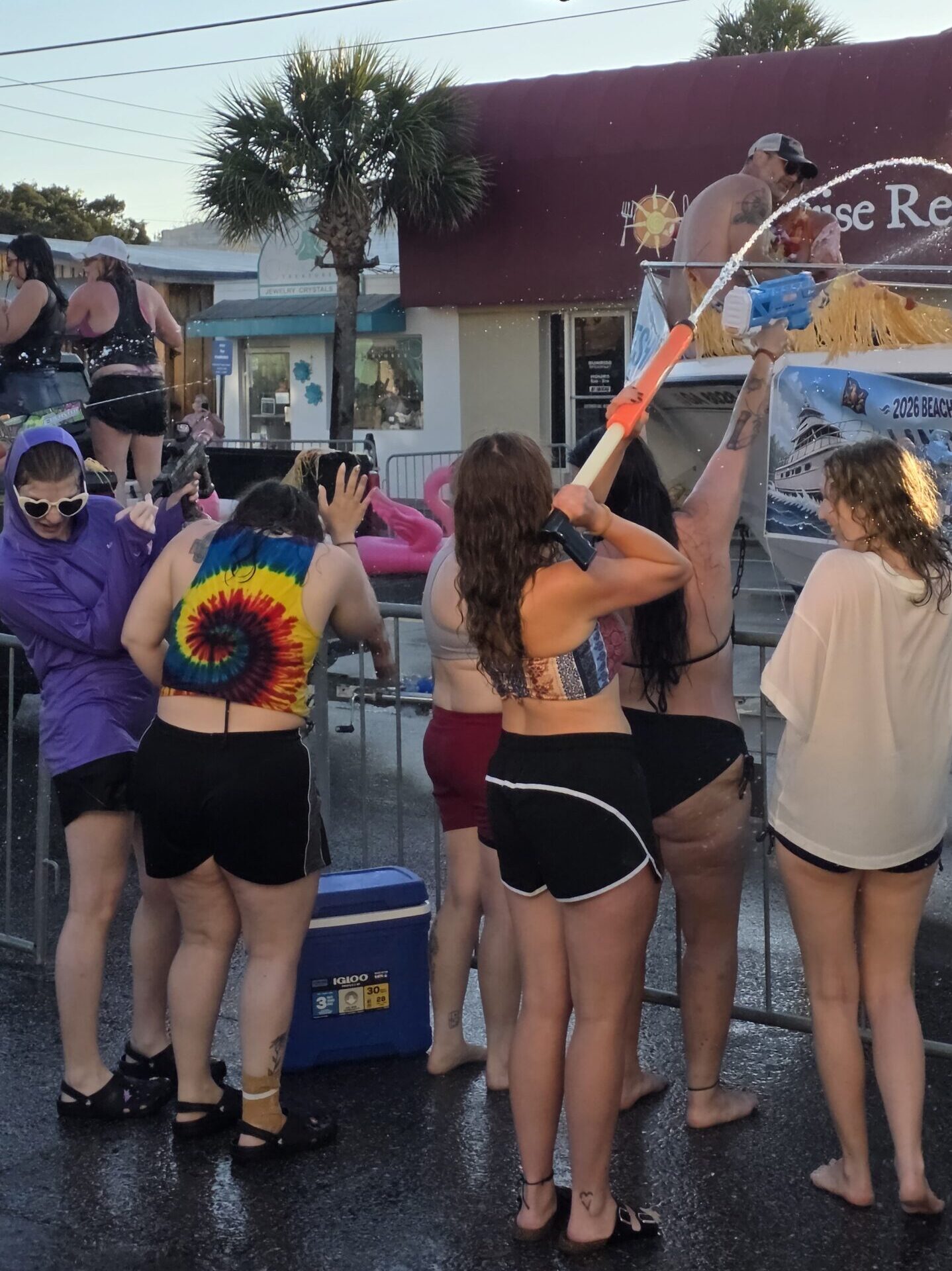 Young women shooting water guns at the Tybee Beach Bum Parade