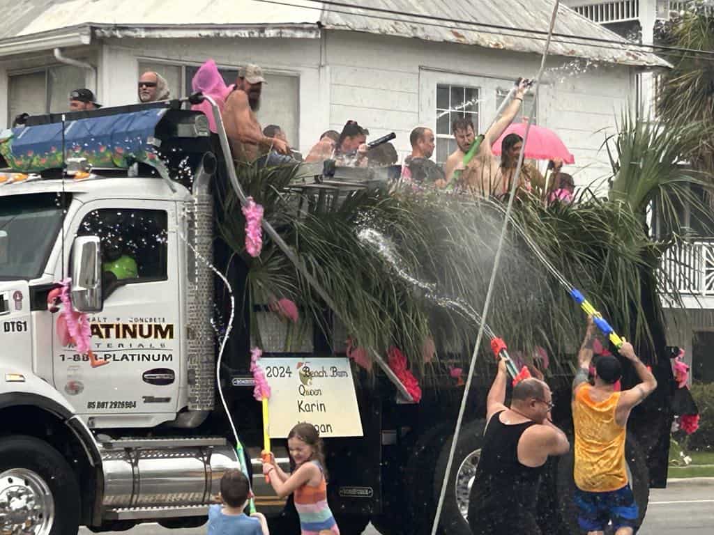 People spraying a homemade float at the Tybee Beach Bum Parade