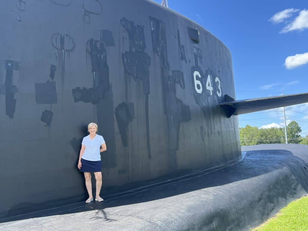 Pam of Discovering Coastal Georgia in front of the submarine museum in St Marys