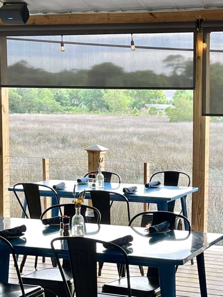 tables on porch overlooking marsh.