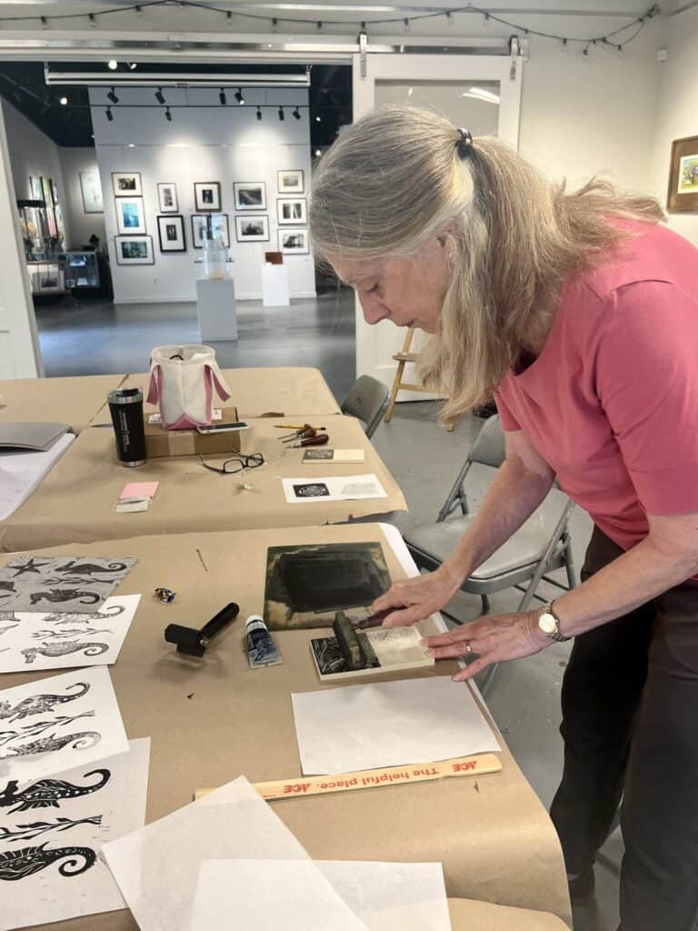 woman making print in studio. 