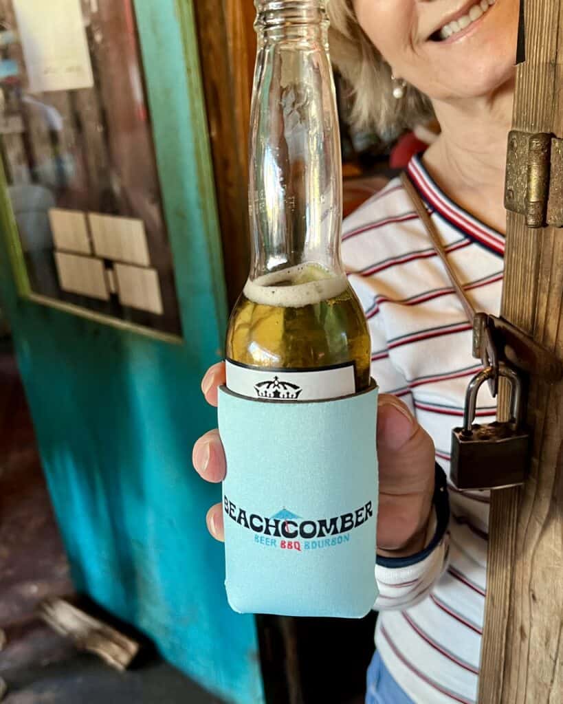 woman toasting with a beer at bbq joint in coastal georgia. 