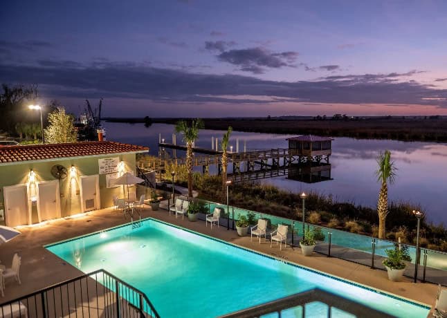 sunset over marsh and a view of the pool at Oaks on the River in Darien, GA. 