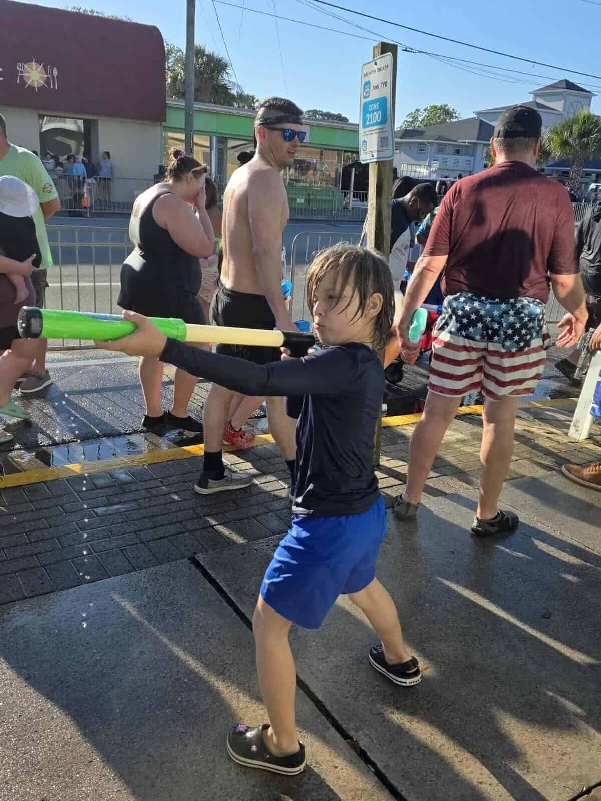 A young boy with a serious face poses with his watergun at the Tybee Beach Bum Parade.
