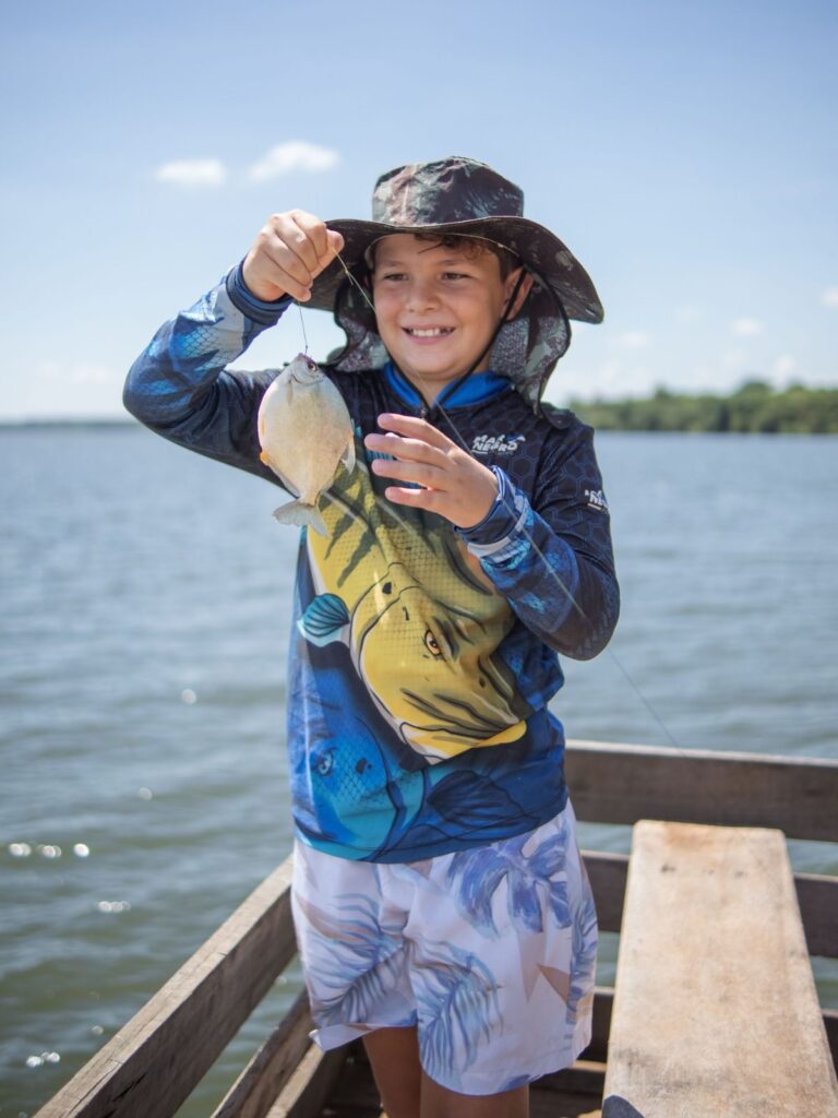 boy holding fish that he caught on charter.